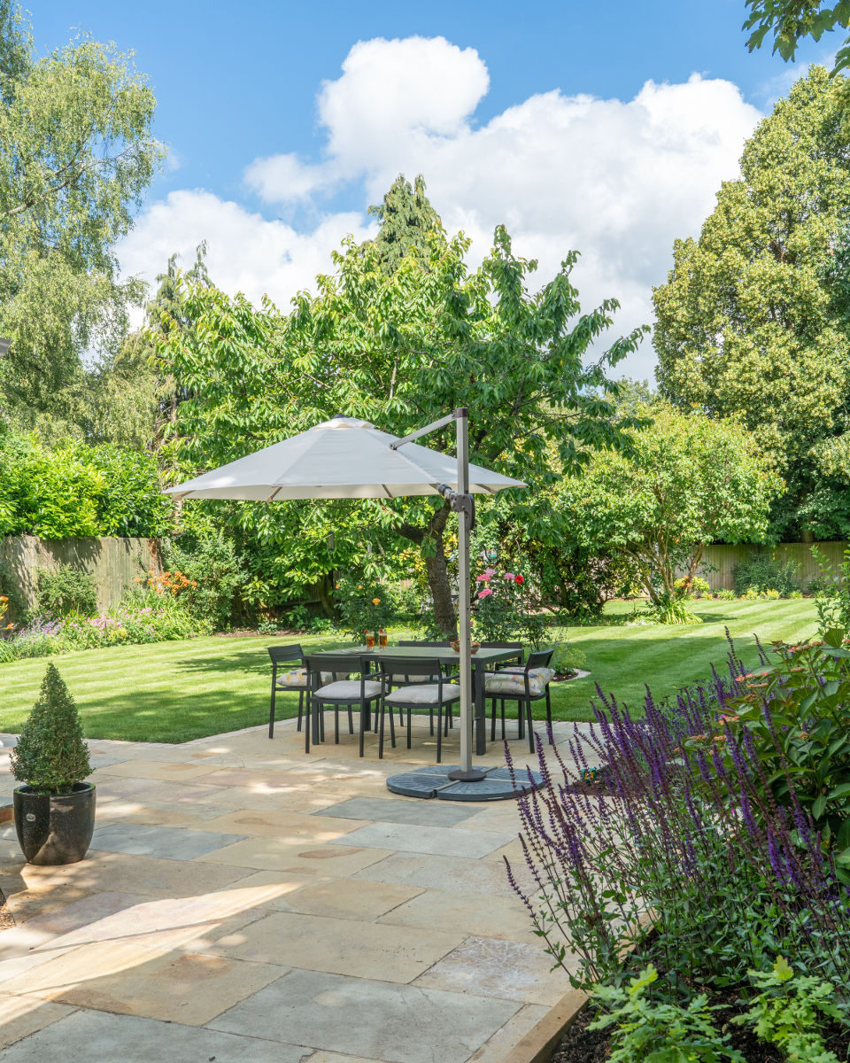 shaded outdoor dining area in landscaped garden