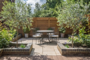 outdoor table and chairs in landscaped residential garden