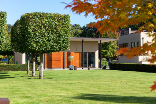 Shot of well maintained grounds leading to property entrance