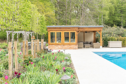 Pool side path with planting to left leading to new pool house