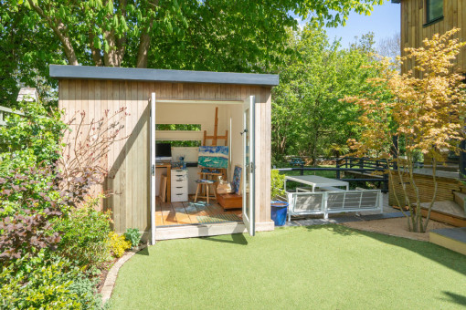 Artists studio in garden surrounded by trees