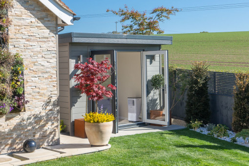 Small garden office in garden overlooking countryside