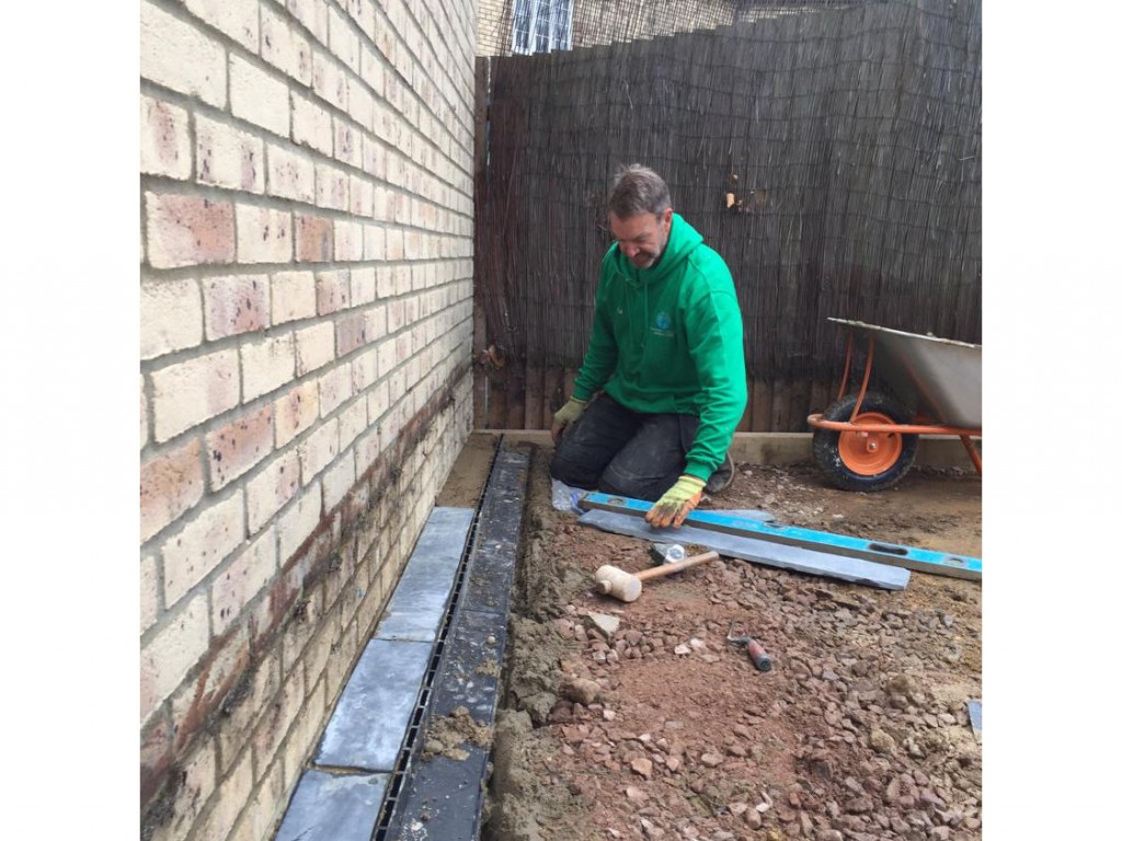 installing brick slot draining system for new patio