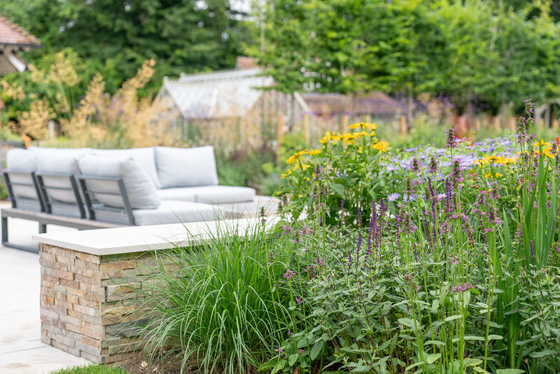 Outdoor seating area surrounded by planting