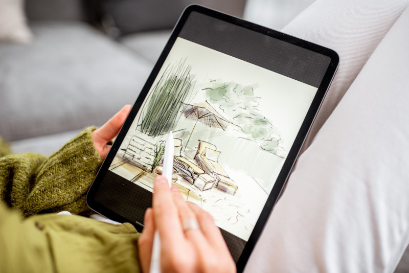 Designer making a landscape drawing on a tablet