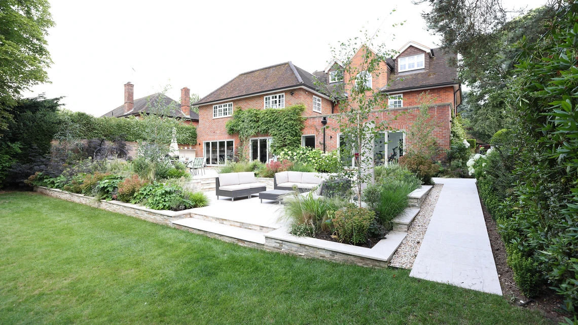 High-end multi-level limestone entertaining terrace and outdoor kitchen