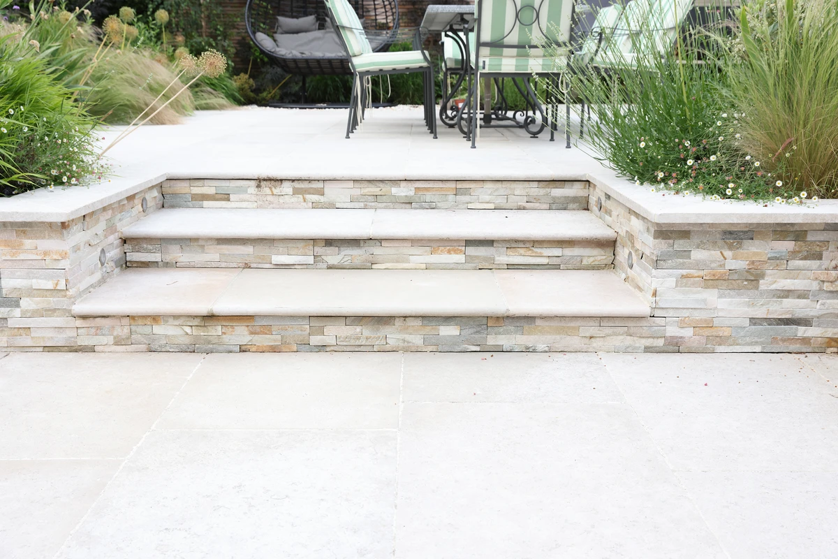 Egyptian limestone paving and split-faced wall cladding on retaining walls